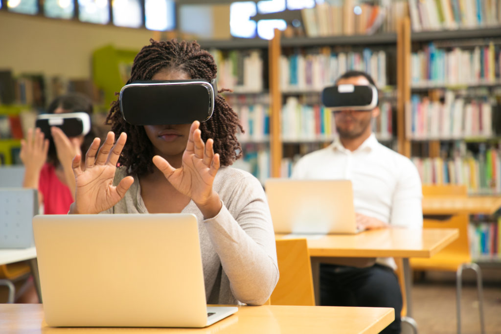 mix raced group of students using vr experience for studying