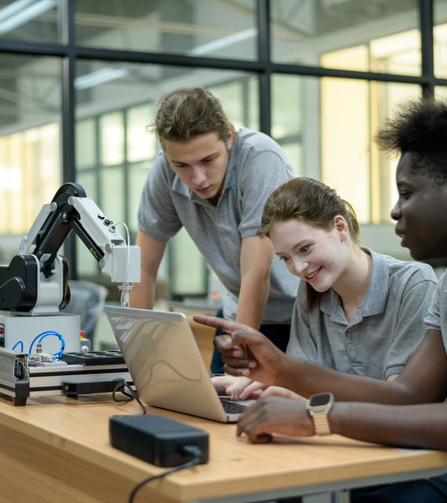 trainee robotics engineer learning with programming and manipulating robot hand